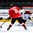 GRAND FORKS, NORTH DAKOTA - APRIL 14: LatviaÕs Gustavs Grigals #29 makes a save while Switzerland's Yannick Lerch #18 and LatviaÕs Pauls Svars #12 looks on during preliminary round action at the 2016 IIHF Ice Hockey U18 World Championship. (Photo by Matt Zambonin/HHOF-IIHF Images)

